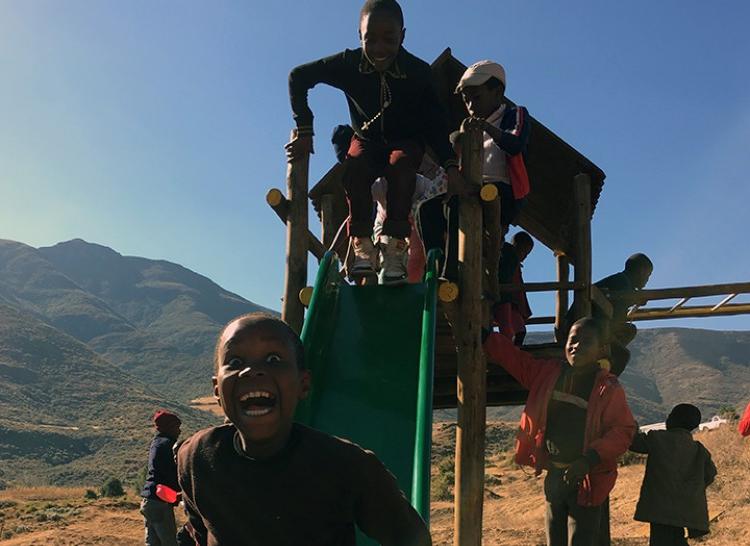 Orphans Sliding On Swing Set